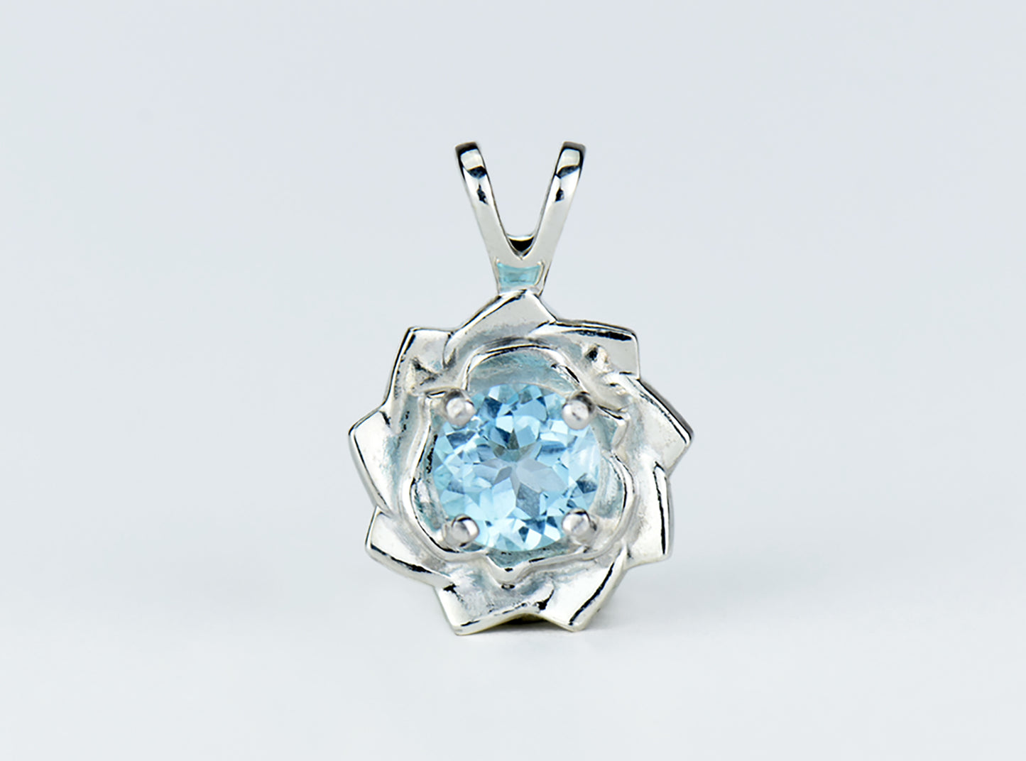 Light Blue Lotus Flower Pendant Necklace. Natural, Sky Blue Topaz gemstone set in handmade premium silver flower pendant.