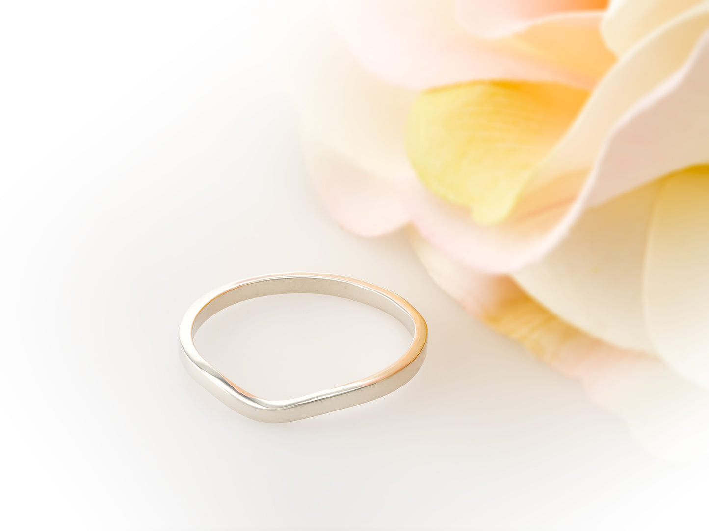 Premium silver curved band for ladies. This Band is great as an overseas travel band. Fits most of our 4 and 6 prong solitaire rings.