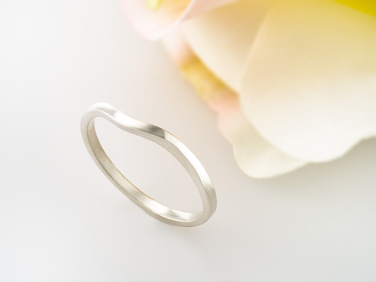 Premium silver curved band for ladies. This Band is great as an overseas travel band. Fits most of our 4 and 6 prong solitaire rings.