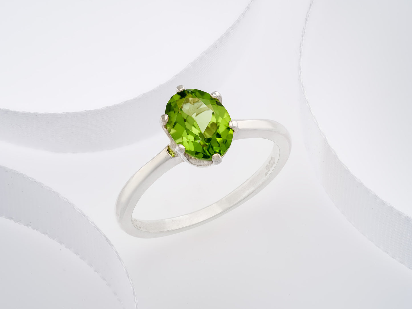 Sparkling green peridot ring. 8x6mm oval faceted natural peridot gemstone in sterling silver.