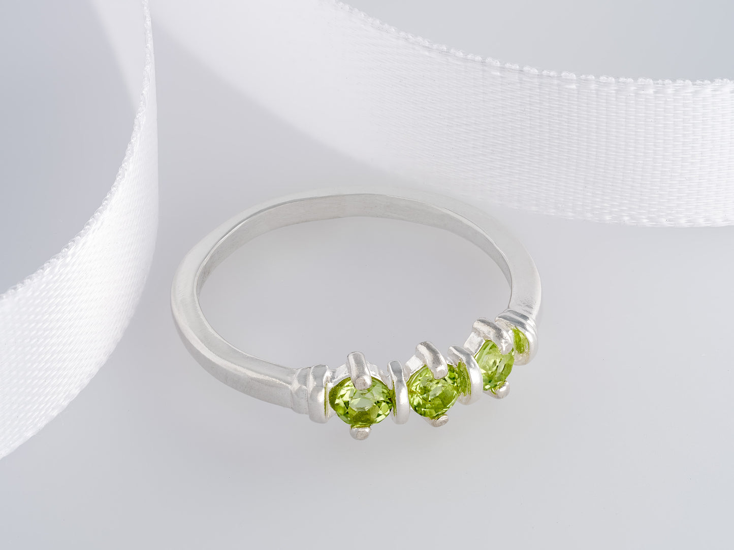 Three-Gemstone Band.  Lively green, natural, peridot!  Three Round Natural Peridot Gemstones set in Sterling Silver.