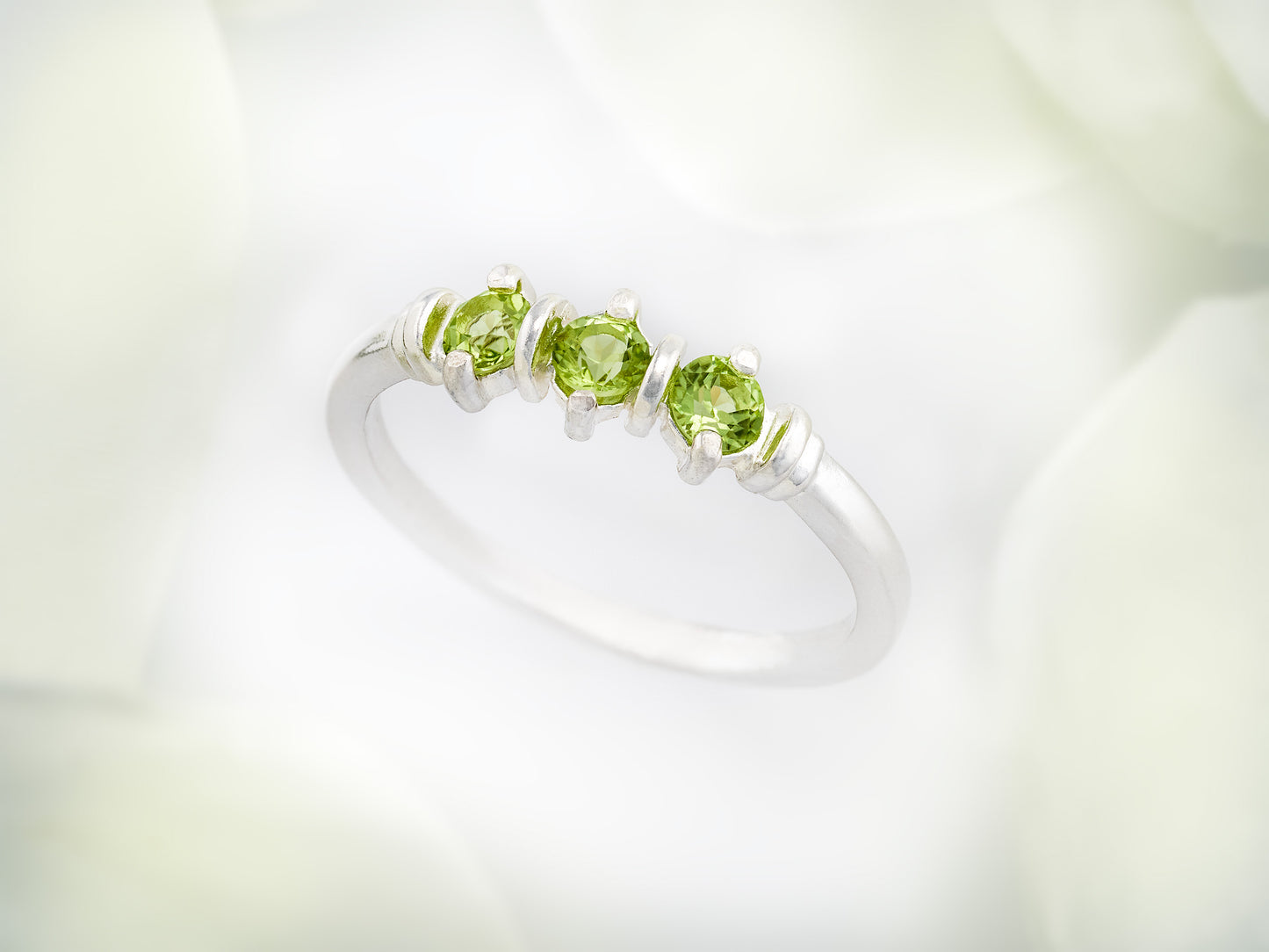 Three-Gemstone Band.  Lively green, natural, peridot!  Three Round Natural Peridot Gemstones set in Sterling Silver.