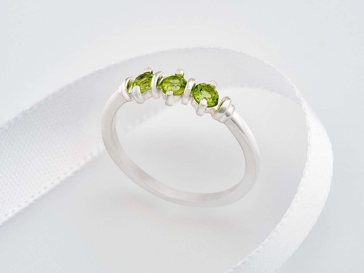 Three-Gemstone Band.  Lively green, natural, peridot!  Three Round Natural Peridot Gemstones set in Sterling Silver.