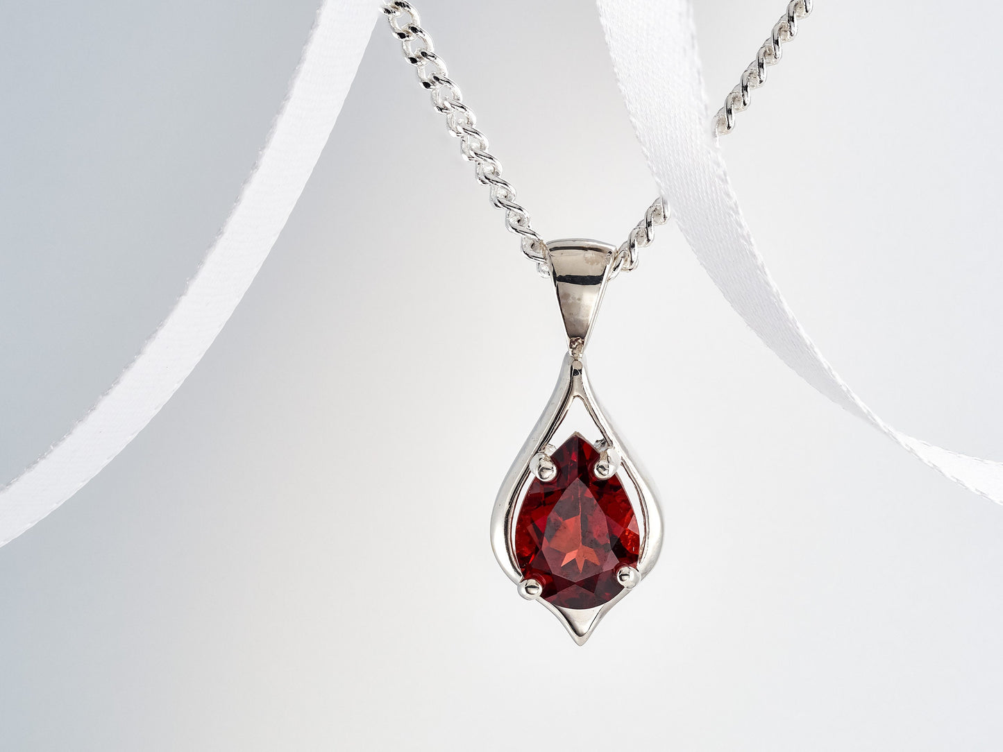 Handmade, striking red, garnet pendant necklace from Brazil. Pear, 10x7mm, 4-Prong, sterling silver pendant.