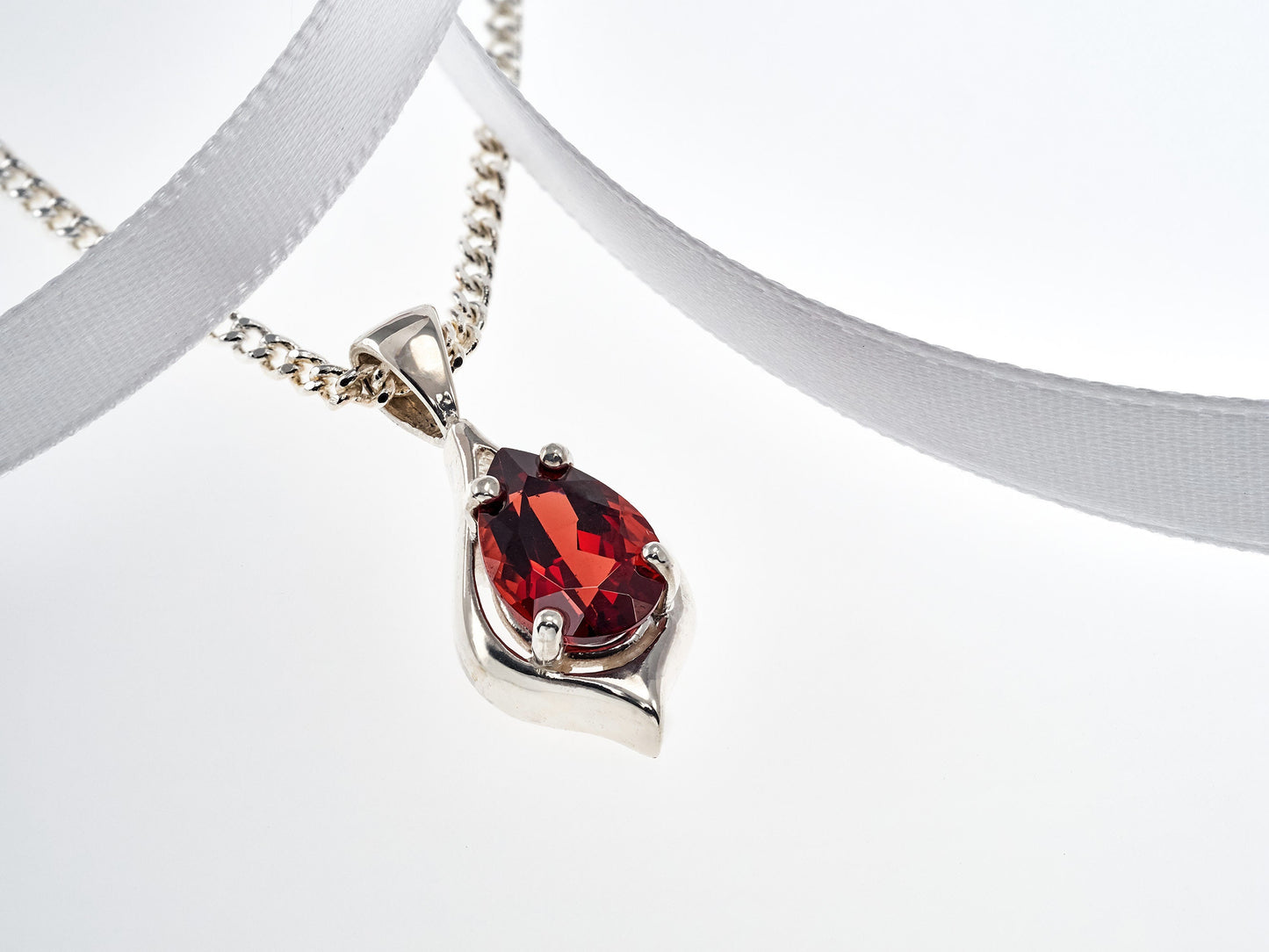 Handmade, striking red, garnet pendant necklace from Brazil. Pear, 10x7mm, 4-Prong, sterling silver pendant.