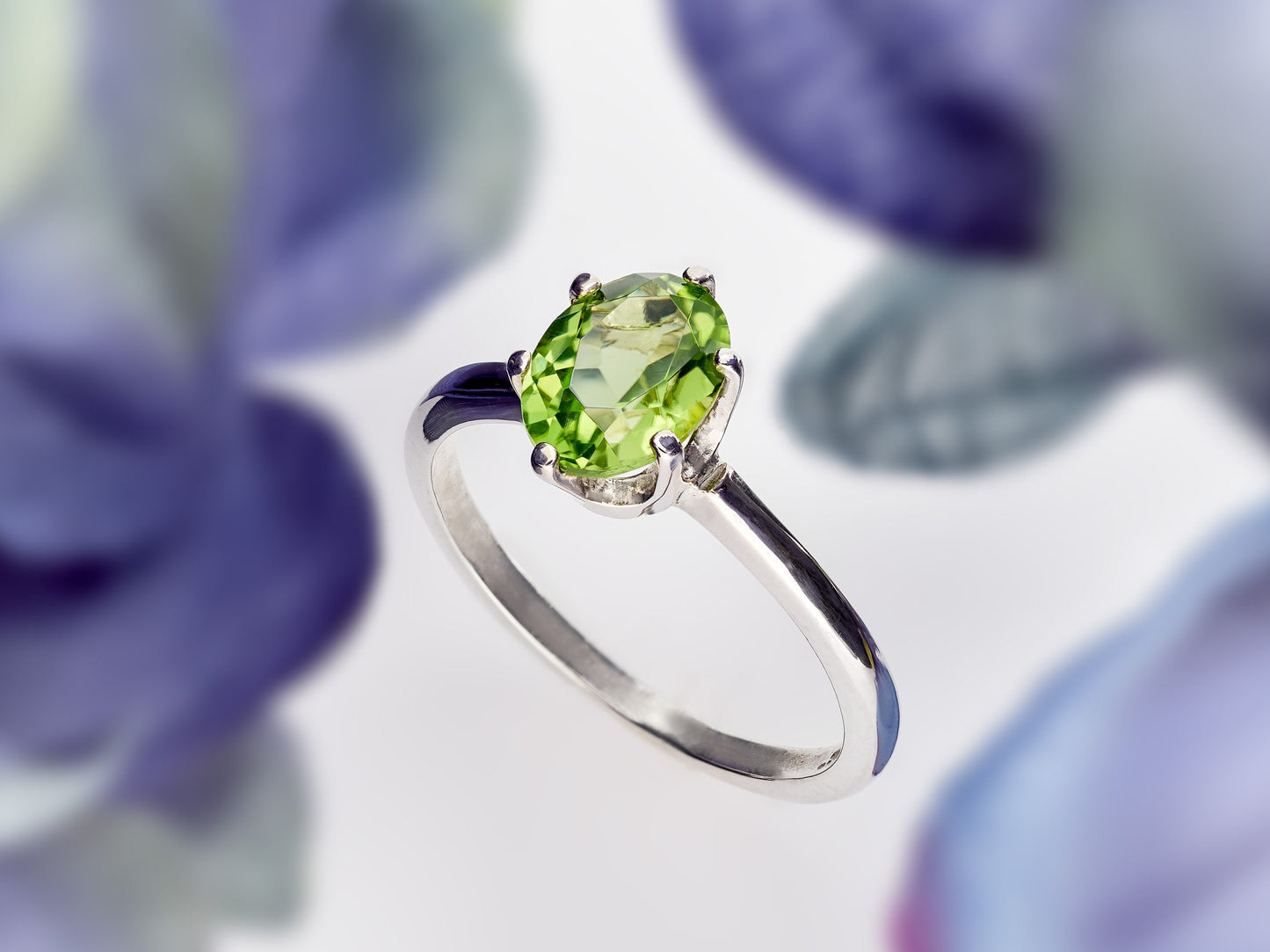 Sparkling green peridot ring. 8x6mm oval faceted natural peridot gemstone in sterling silver.