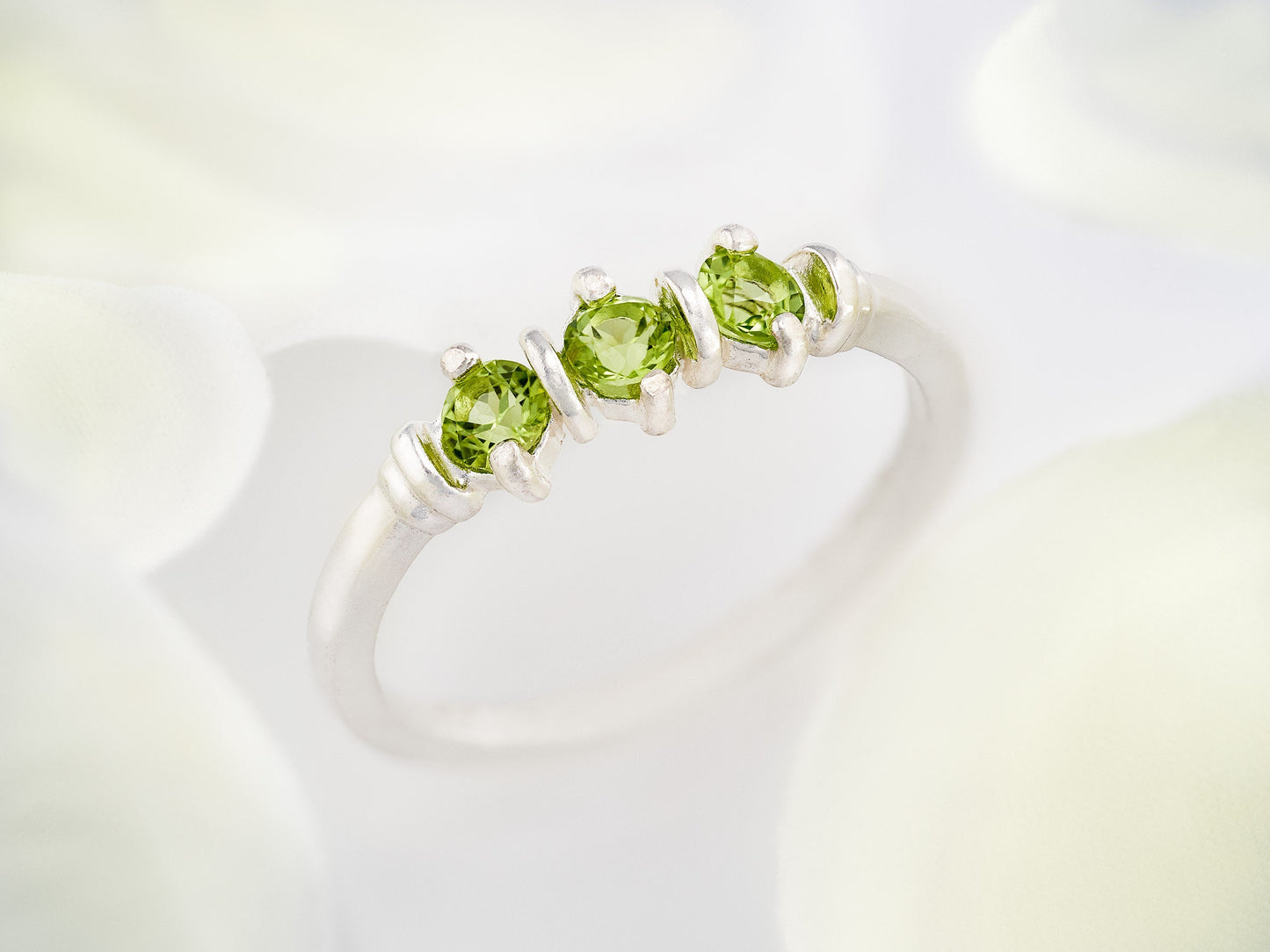 Three-Gemstone Band.  Lively green, natural, peridot!  Three Round Natural Peridot Gemstones set in Sterling Silver.