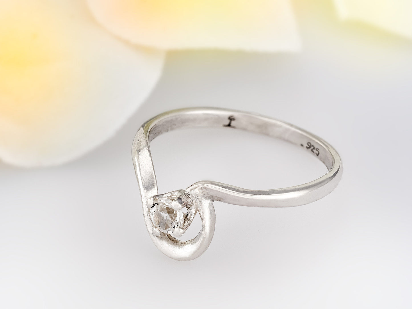 April birthstone, petite half heart style silver ring. 3mm round faceted White Topaz as the diamond alternative.