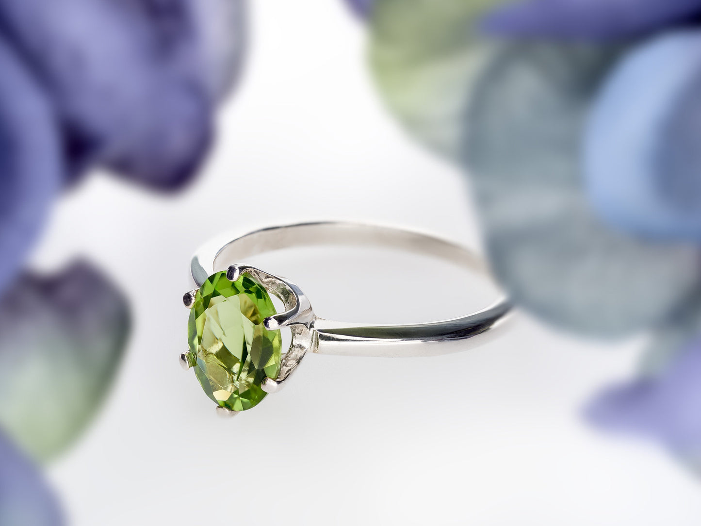 Sparkling green peridot ring. 8x6mm oval faceted natural peridot gemstone in sterling silver.