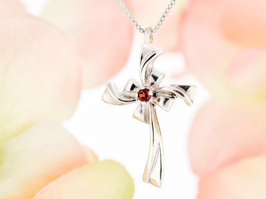 Red Garnet Silver Ribbon Cross Necklace. Handmade, sterling silver pendant with a natural, round faceted, garnet gem.